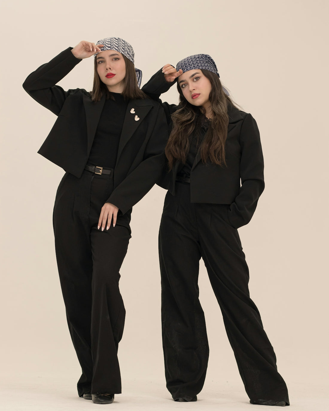 Two women in black suits and headscarves
