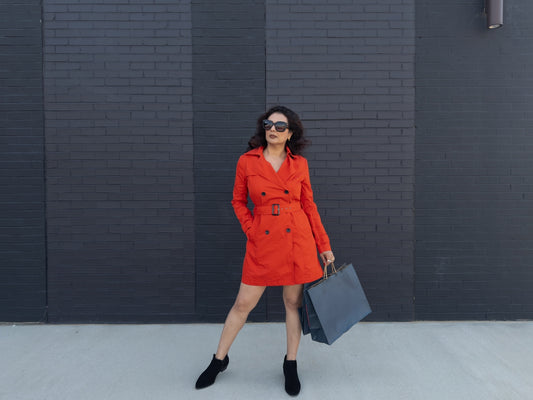 Woman in red dress holding shopping bags